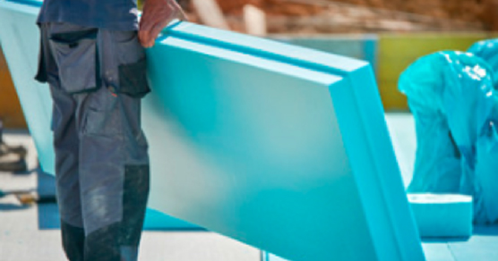 Photo of worker holding foam sheets