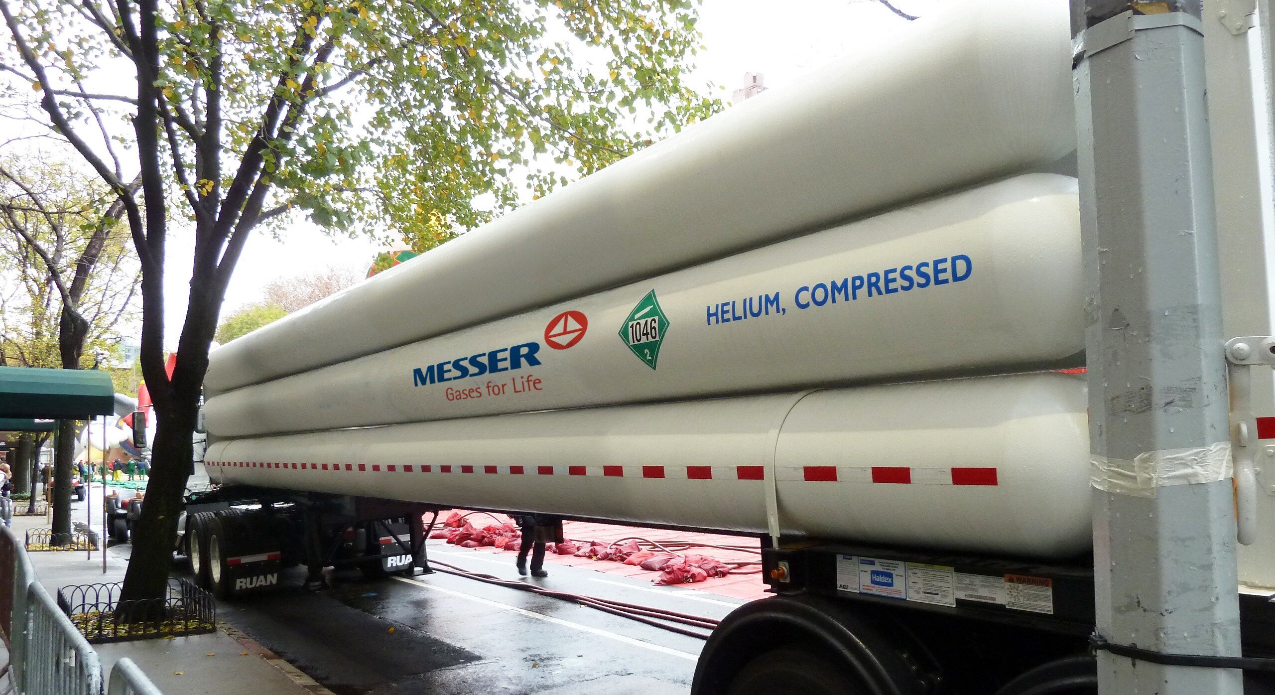 Messer truck carrying large helium compressed gas tubes parked on a city street